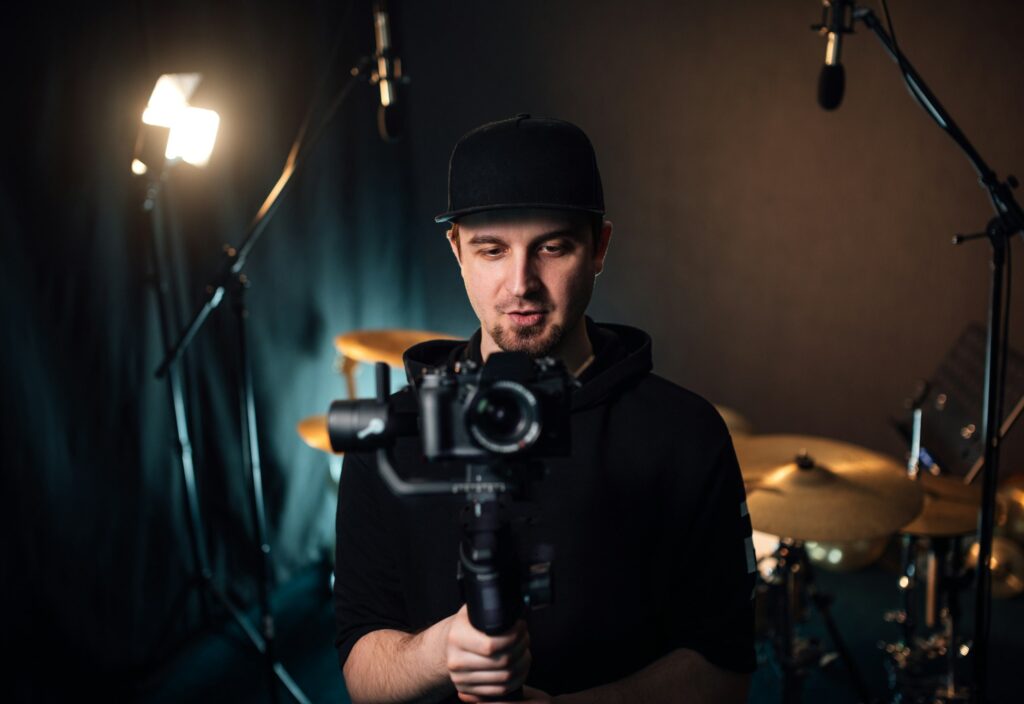 Videographer filming at a recording studio.